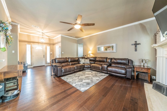 living room with ceiling fan, plenty of natural light, dark hardwood / wood-style floors, and ornamental molding