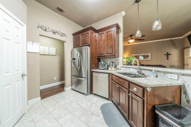 kitchen with ceiling fan, sink, stainless steel appliances, tasteful backsplash, and light tile patterned floors