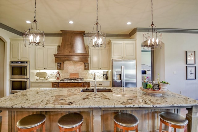 kitchen with custom range hood, stainless steel appliances, and hanging light fixtures