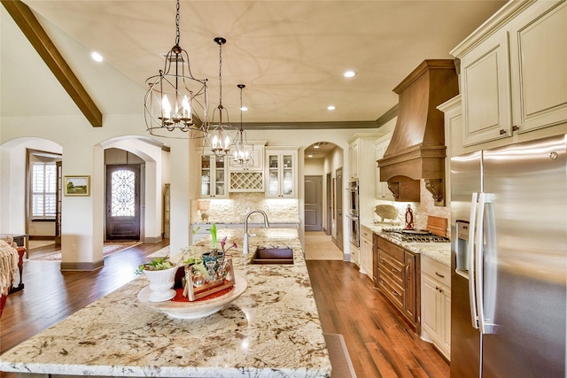 kitchen featuring pendant lighting, a large island, dark wood-type flooring, and stainless steel appliances