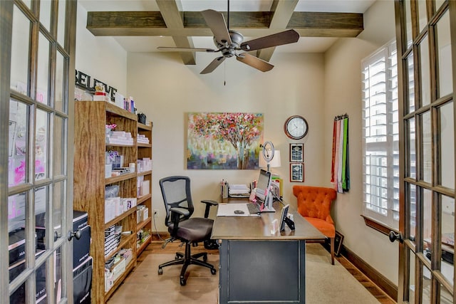 home office featuring french doors, light wood-type flooring, ceiling fan, and beam ceiling