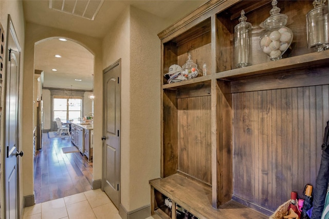 mudroom with light hardwood / wood-style floors