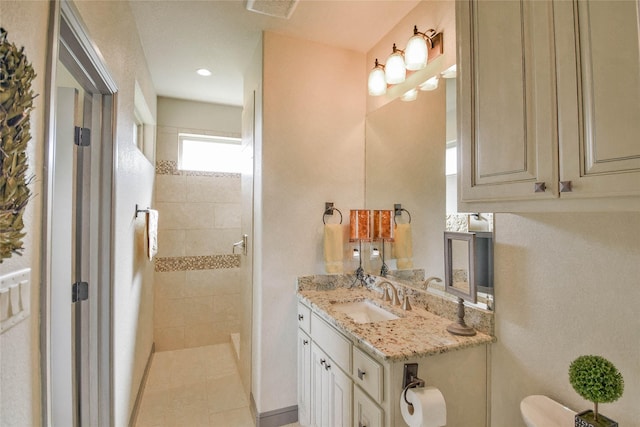 bathroom featuring tile patterned floors, vanity, and toilet