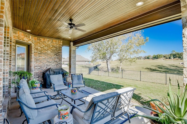 view of patio featuring grilling area, ceiling fan, and a rural view