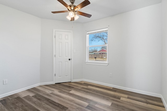 empty room with ceiling fan and dark hardwood / wood-style floors