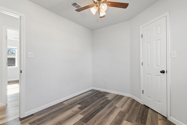 spare room with ceiling fan and dark hardwood / wood-style floors