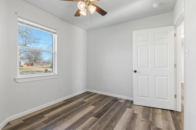 spare room featuring dark hardwood / wood-style floors and ceiling fan