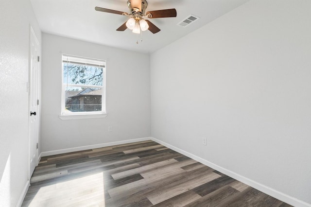 spare room featuring dark hardwood / wood-style floors and ceiling fan