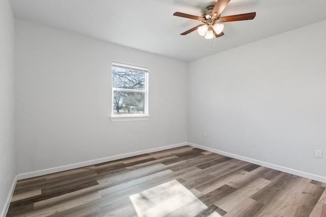 empty room with ceiling fan and wood-type flooring