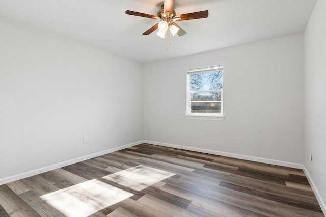 empty room featuring dark hardwood / wood-style flooring and ceiling fan