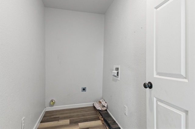 washroom featuring electric dryer hookup, hookup for a washing machine, and dark hardwood / wood-style flooring