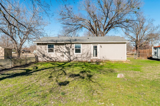 back of property featuring a lawn