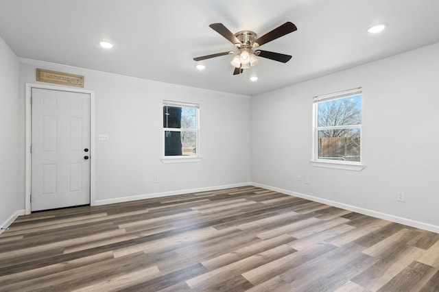 unfurnished room with dark hardwood / wood-style flooring, crown molding, and ceiling fan