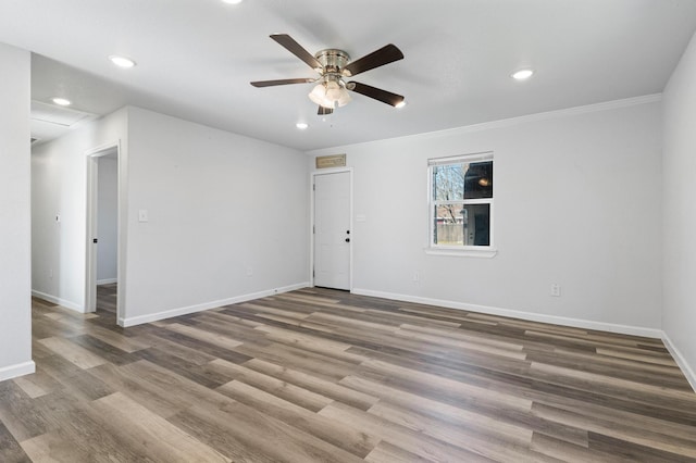 unfurnished room featuring crown molding, wood-type flooring, and ceiling fan