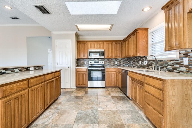 kitchen with sink, appliances with stainless steel finishes, tasteful backsplash, ornamental molding, and a textured ceiling