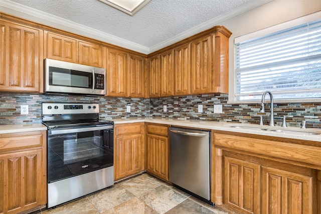 kitchen featuring appliances with stainless steel finishes, sink, a textured ceiling, and backsplash