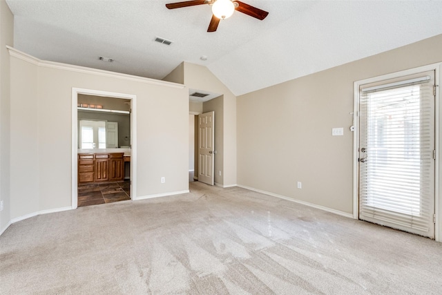 interior space with a textured ceiling, ceiling fan, and lofted ceiling