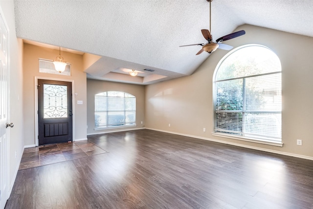 entrance foyer featuring ceiling fan, dark hardwood / wood-style flooring, lofted ceiling, and a textured ceiling