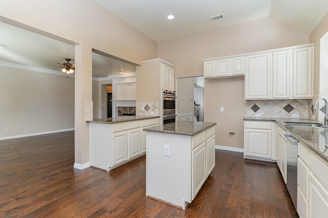 kitchen featuring backsplash, white cabinetry, dark wood-type flooring, and sink