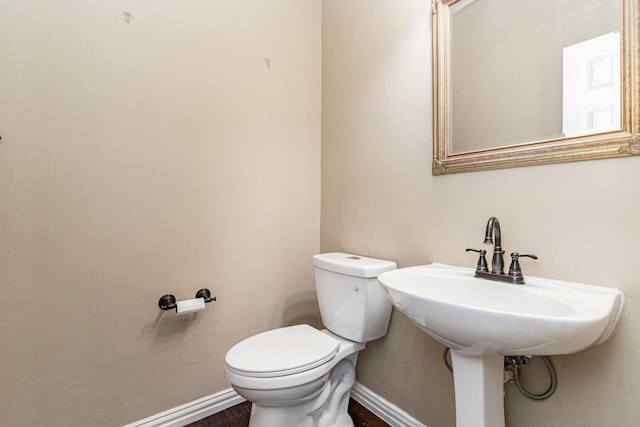 bathroom with wood-type flooring and toilet