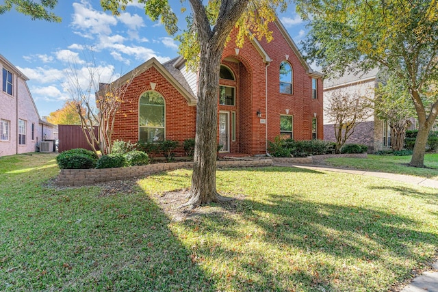 view of property with central AC unit and a front yard