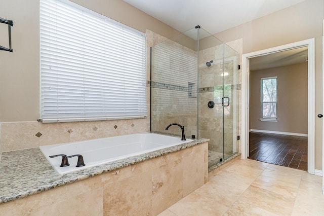 bathroom featuring independent shower and bath and hardwood / wood-style flooring