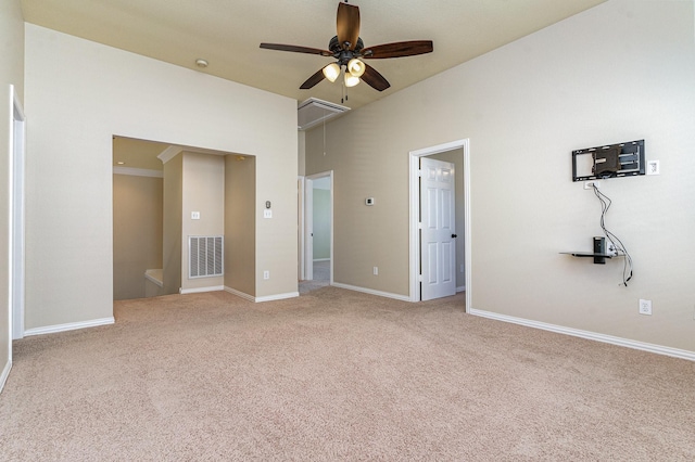 unfurnished bedroom featuring carpet flooring, ceiling fan, and a towering ceiling