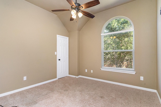 unfurnished room with ceiling fan, lofted ceiling, and light carpet