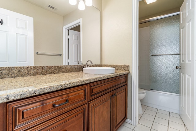 full bathroom with tile patterned flooring, enclosed tub / shower combo, vanity, and toilet