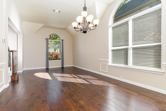 interior space with lofted ceiling, dark wood-type flooring, and an inviting chandelier