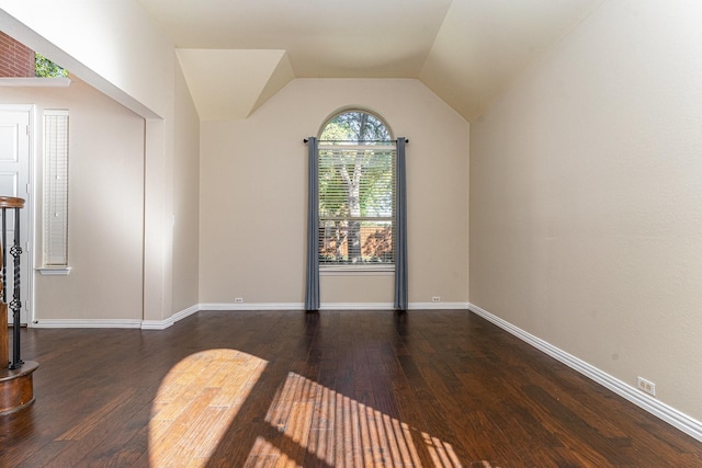 additional living space with lofted ceiling and dark hardwood / wood-style floors