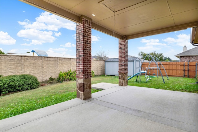 view of patio featuring a shed and a playground