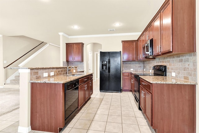 kitchen featuring sink, light stone counters, crown molding, light tile patterned floors, and black appliances