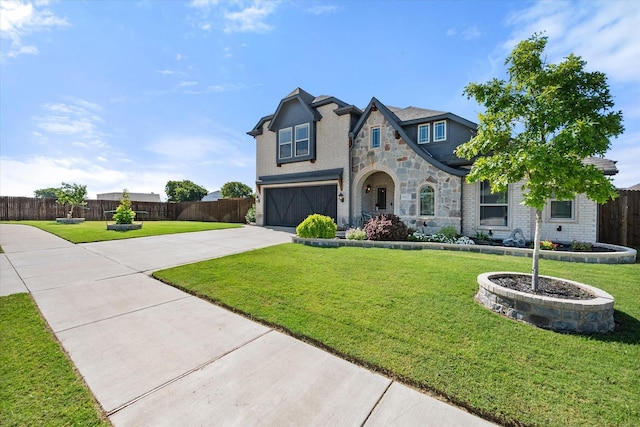 view of front of property with a garage and a front lawn