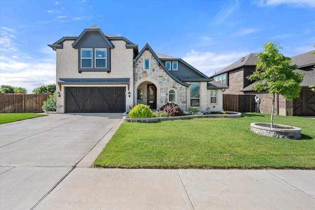 view of front of home with a front yard and a garage