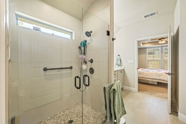 bathroom featuring vanity, tile patterned floors, a wealth of natural light, and a shower with shower door