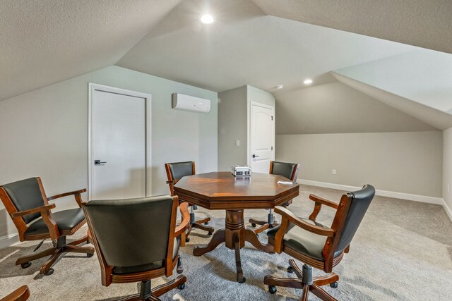 carpeted office featuring lofted ceiling, a wall mounted AC, and a textured ceiling