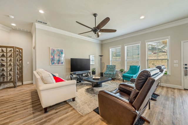 living room with crown molding, ceiling fan, and light hardwood / wood-style flooring