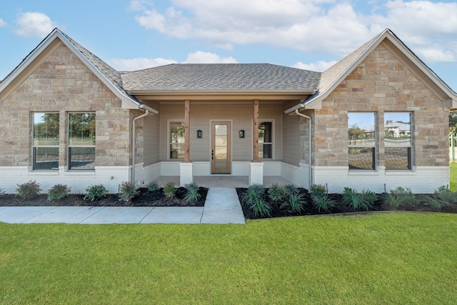 view of front of property with covered porch and a front yard