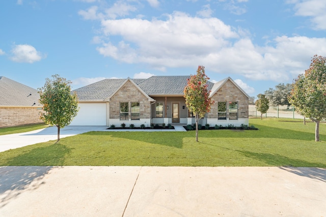 view of front of house featuring a garage and a front lawn