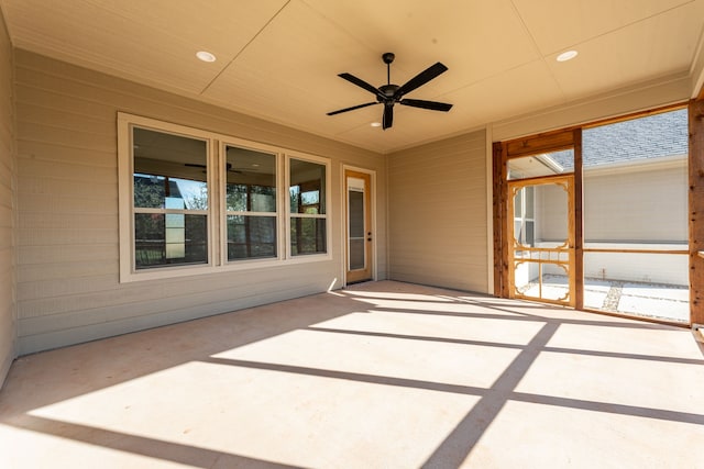 unfurnished sunroom featuring ceiling fan