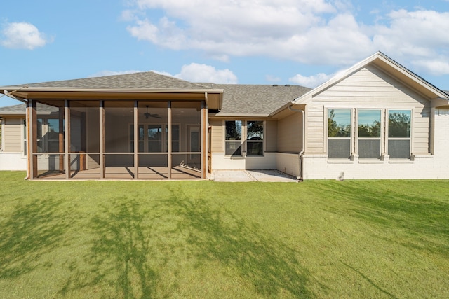 back of house with ceiling fan, a sunroom, a patio, and a lawn