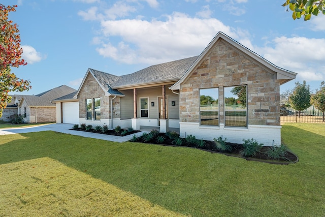 view of front of property featuring a garage and a front lawn