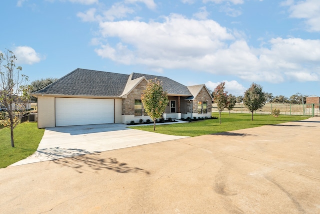 view of front of property with a garage and a front lawn