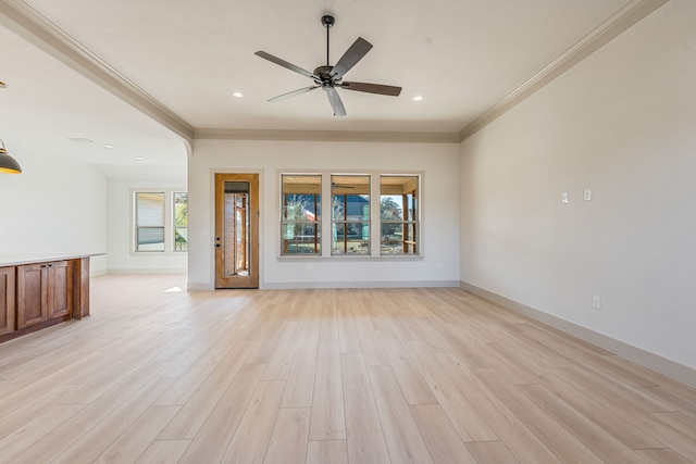 unfurnished living room with ornamental molding, ceiling fan, and light wood-type flooring