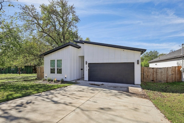 view of front facade with a front yard and a garage