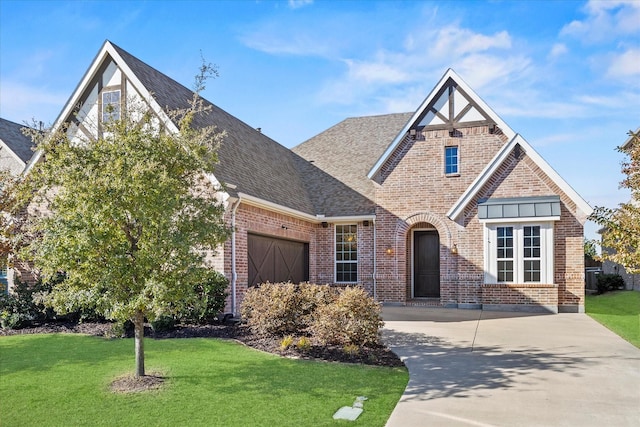 view of front of property with a front yard and a garage