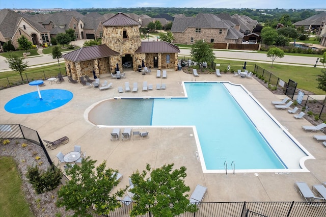 view of swimming pool featuring pool water feature and a patio area