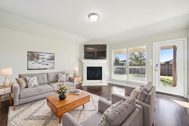 living room featuring dark hardwood / wood-style flooring and lofted ceiling