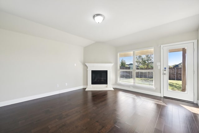 unfurnished living room featuring dark hardwood / wood-style floors and vaulted ceiling